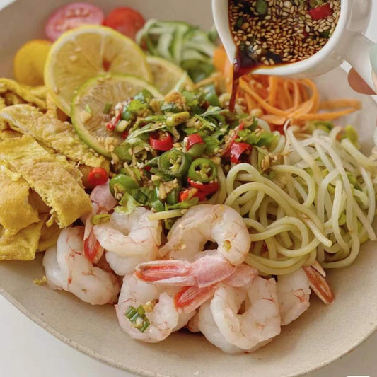 Chilled noodles with shrimp, spicy chili oil, and fresh coriander.