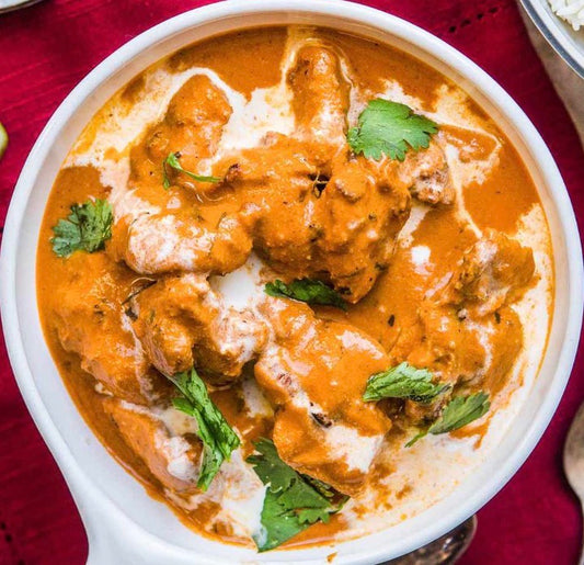 Butter chicken on brown rice with rich, spiced tomato-cream sauce.